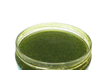 Gel body scrub fir green in a jar macro isolated on a white background.