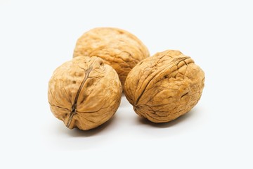 Three whole walnuts isolated on white background