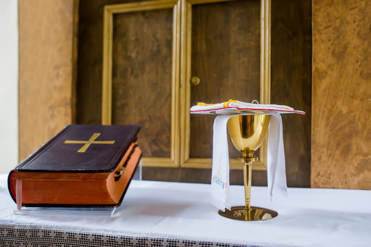 Bible with cross on table ready for prayer in horizontal orientation. Closeup photo.