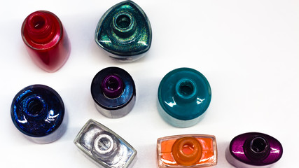  gel Polish for manicure on a white table. Scattered nail Polish in the beauty salon. The choice of...
