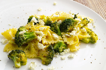 boiled farfalle pasta with fried in garlic oil broccoli, feta, and black pepper.