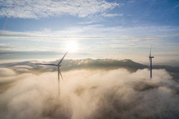 Wind power generator before sunrise sunset ，Wind power generation in the sea of clouds