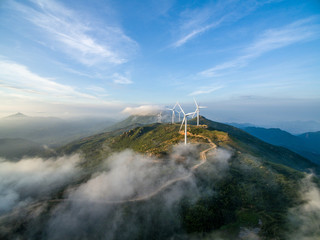 Wind power generator before sunrise sunset ，Wind power generation in the sea of clouds