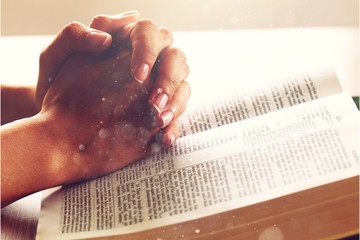 Young woman pray with holy bible