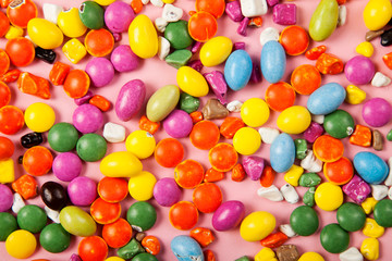 Colorful lollipops and different colored round candy. Top view.