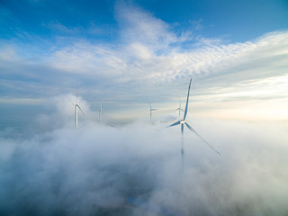 Wind power generator before sunrise sunset ，Wind power generation in the sea of clouds
