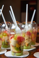 sliced fruits in plastic cup. healthy food catering. Fruit salad. Fitness food.