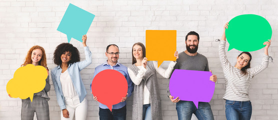 Group of diverse people holding colorful speech bubbles