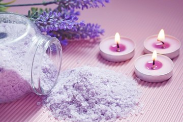 Obraz na płótnie Canvas Bath salt with the scent of lavender on a pink background.