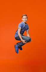 Fototapeta na wymiar Cheerful school boy jumping in bomb style