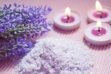 Obraz na płótnie Canvas Bath salt with the scent of lavender on a pink background.