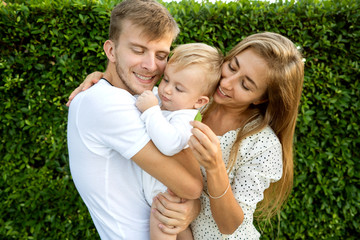 happy family on tropical island at sunset playing with son