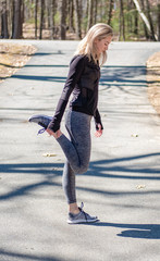 Young woman running and stretching