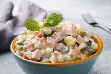 Traditional Russian Christmas and New year salad Olivier in bowl. Selective focus