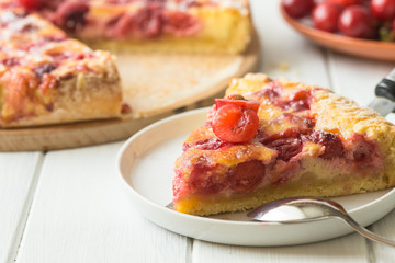 Clafoutis cherry pie on wooden background. Klafuti french cherry pie.