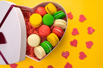 Macaroons in a gift box. Heart-shaped box. Copy space.