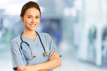 Attractive young female doctor  on background