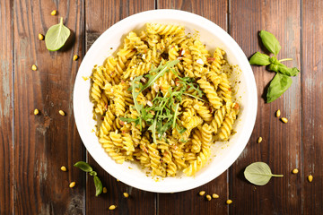 pasta with pesto sauce and arugula