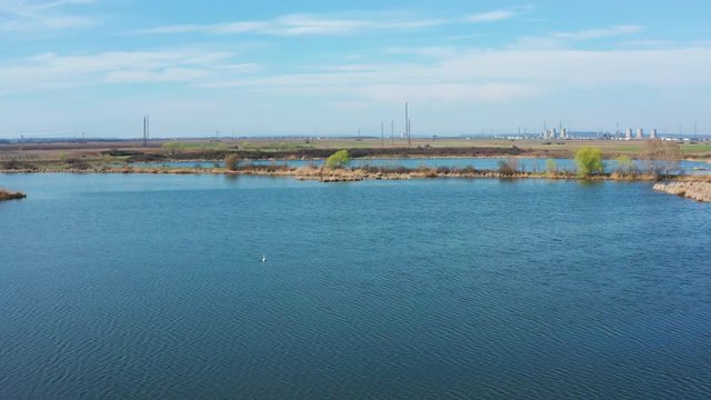 flying over a small lake during the spring