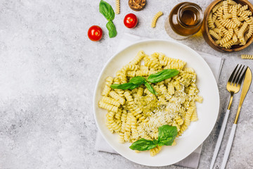 Fusilli pasta with basil, pesto sauce and parmesan cheese
