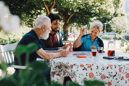 People playing cards in garden