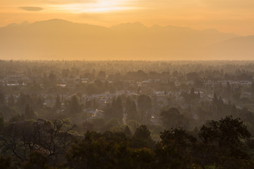 Hazy dawn view of west San Fernando Valley neighborhoods in the city of Los Angeles, California.  The San Gabriel Mountains are in the background.