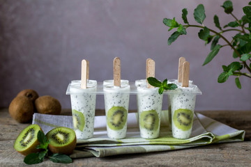 Kiwi yogurt ice cream popsicles. Healthy dessert. Homemade product. Summer background