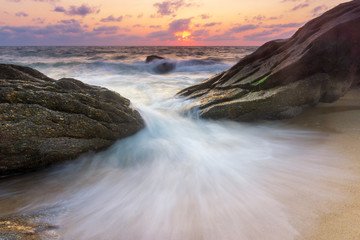 Fototapeta na wymiar Beautiful Tropical seascape wave hit the rock during sunset