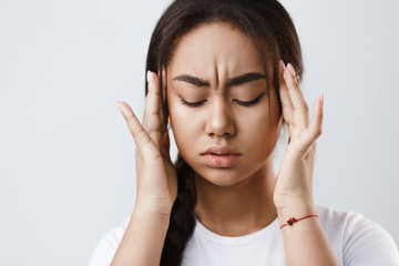 Terrible headache. Girl touching her temples, feeling stress