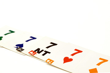 Bridge cards with 7 different suits on a white background. Equipment for a sports game of bridge. Betting concept.