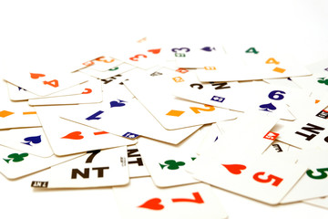 Cards for bridge of different colors on a white background. Equipment for a sports game of bridge....