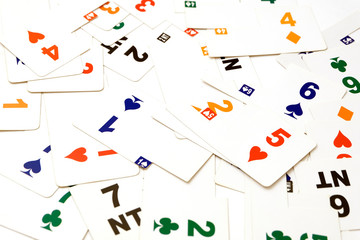 Cards for bridge of different colors on a white background. Equipment for a sports game of bridge. Betting concept. Corruption in sports. A bribe in the game, a bribe in real life.