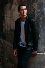 Attractive, sexy guy standing on the street in sunglasses. self-confidence, flatulence and arrogance. model, posing, portrait of a young man