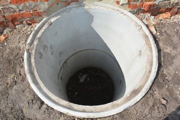 Concrete septic tank. Sewer tank hole installation outdoors