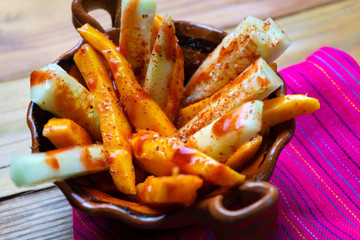 Mexican cucumber and mangoes  with chili powder and chamoy