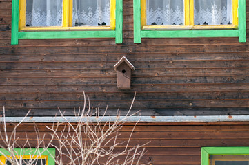 A small bird house on the facade