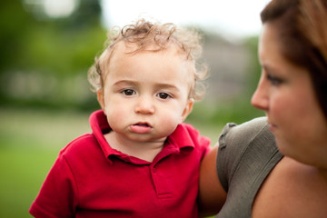 Happy Mother Holding Toddler Son Outside - Color Portrait