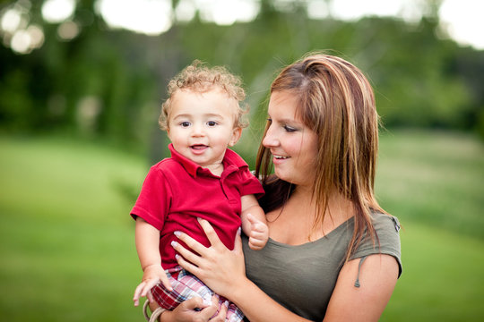 Happy Mother Holding Toddler Son Outside - Color Portrait