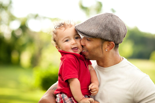 Happy Dad Holding Toddler Son Outside - Color Portrait