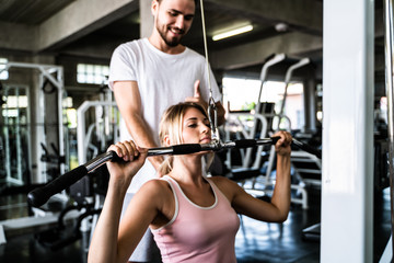 Sport man trainning women work out in fitness gym sport club