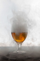 glass of whiskey and smoke