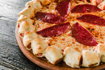 tasty unusual pizza with sausage in a side