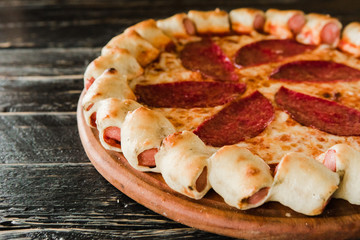 tasty unusual pizza with sausage in a side
