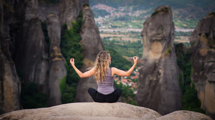 Woman Meditating on a Rock in Meteora Greece