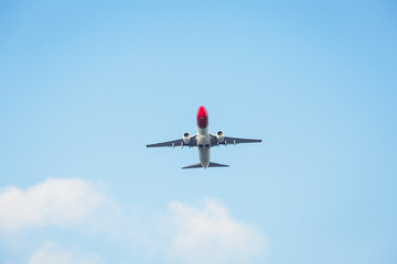 Passenger airplane isolated against the blue sky. Front view.