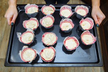 Cooking cupcakes at home. Cheesecakes on the baking sheet