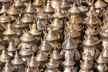 Fototapeta na wymiar Traditional Arab kettles for tea for sale on the street market in Essaouira, Morocco