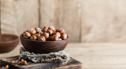 Hazelnuts on rustic wooden background. Food background. Print for kitchen