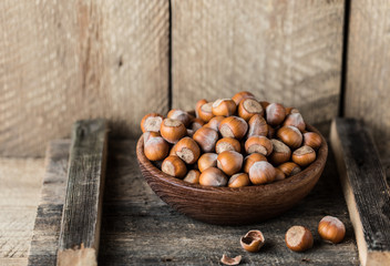 Hazelnuts on rustic wooden background. Food background. Print for kitchen