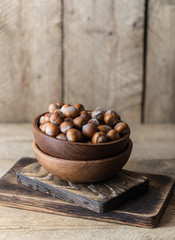 Hazelnuts on rustic wooden background. Food background. Print for kitchen